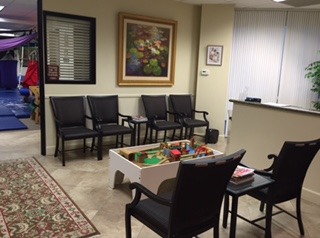 A waiting room with chairs and tables in it